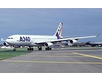 Airbus profits halved but hopes to meet delivery target
