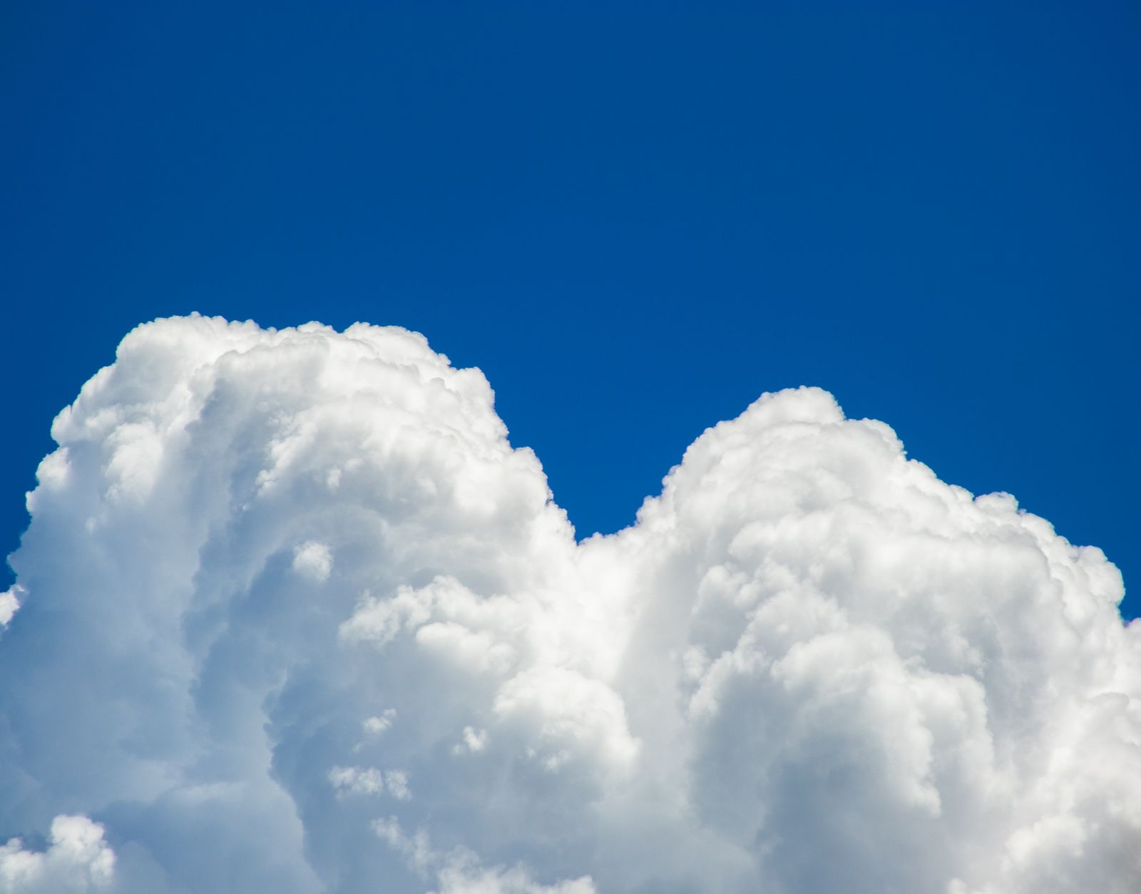 Why does a cumulus cloud drifting overhead often weigh several hundred tonnes and still hang in the sky as if it weighed nothing at all?